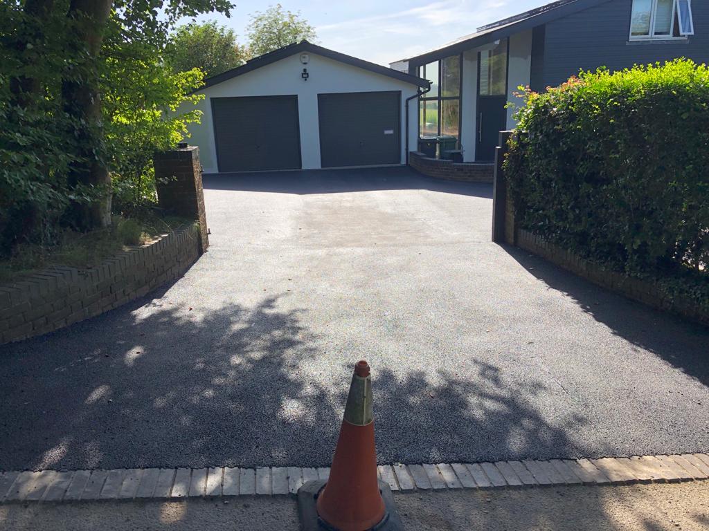 This is a photo of a bitumen driveway which is in the process of being installed by Coomera Surfacing Solutions